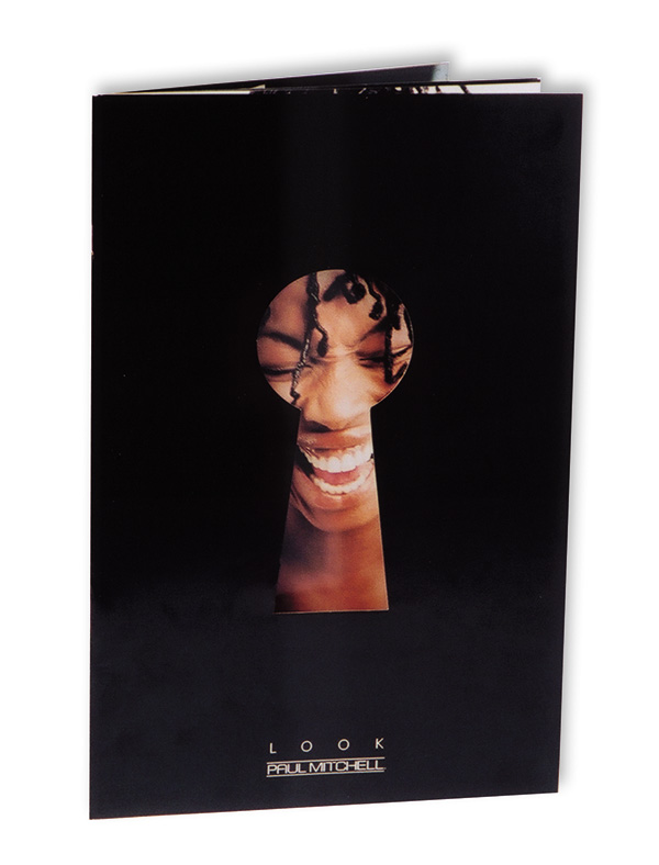 Paul Mitchell lookbook with a keyhole die cut revealing a smiling face